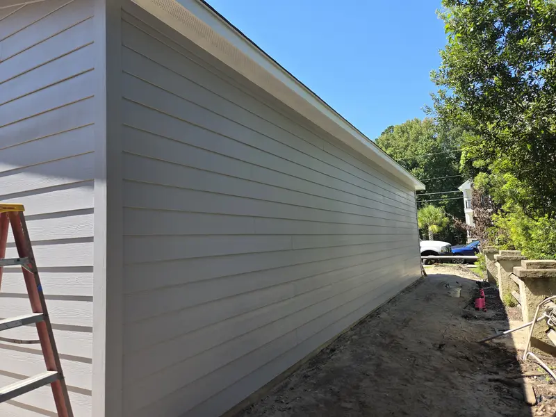 Long garage side wall with new lap siding painted grey, Lake Waccamaw, NC